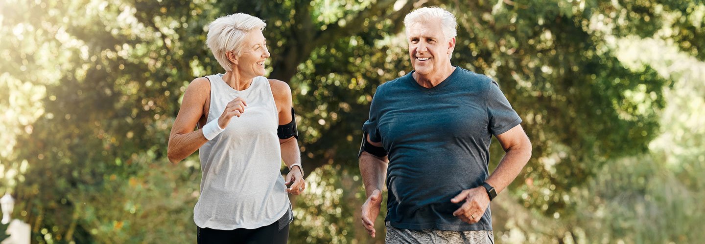 man and woman joggin in the sunshine