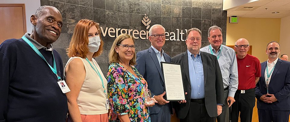 group of people presenting award in board room