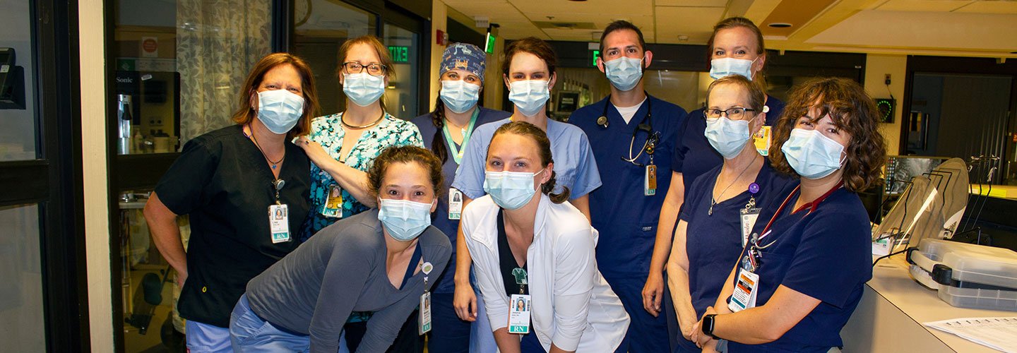 group of smiling masked nurses