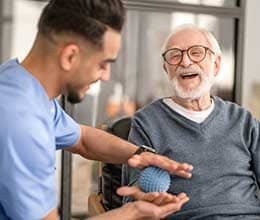 man and caregiver laughing