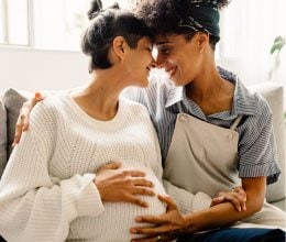 woman smiling at pregnat woman