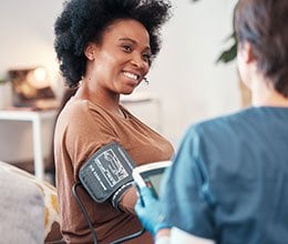 smiling woman getting her blood presssure checked