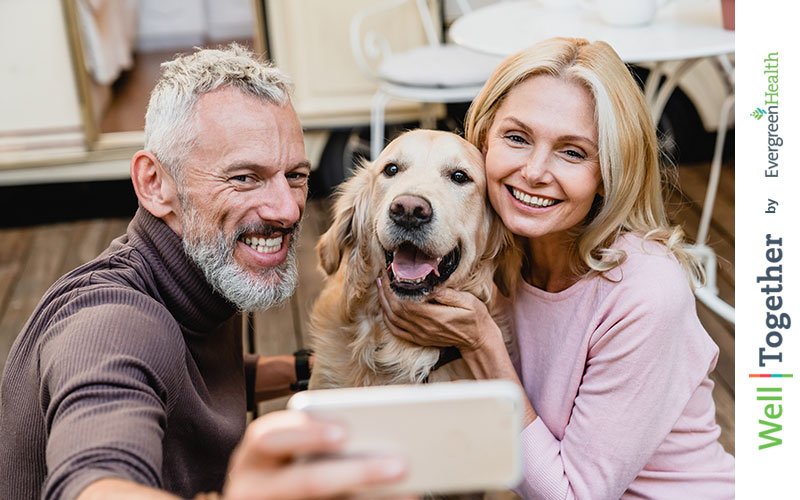 couple taking selfie with their dog